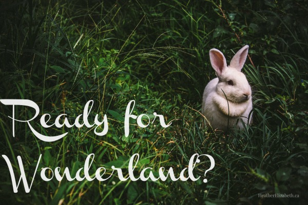A while rabbit rests on lush deep green grass. White scroll text reads: Ready For Wonderland?